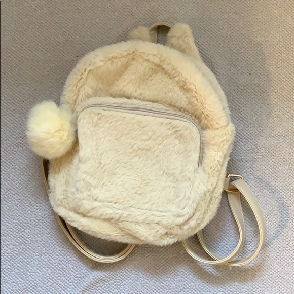 white furry backpack